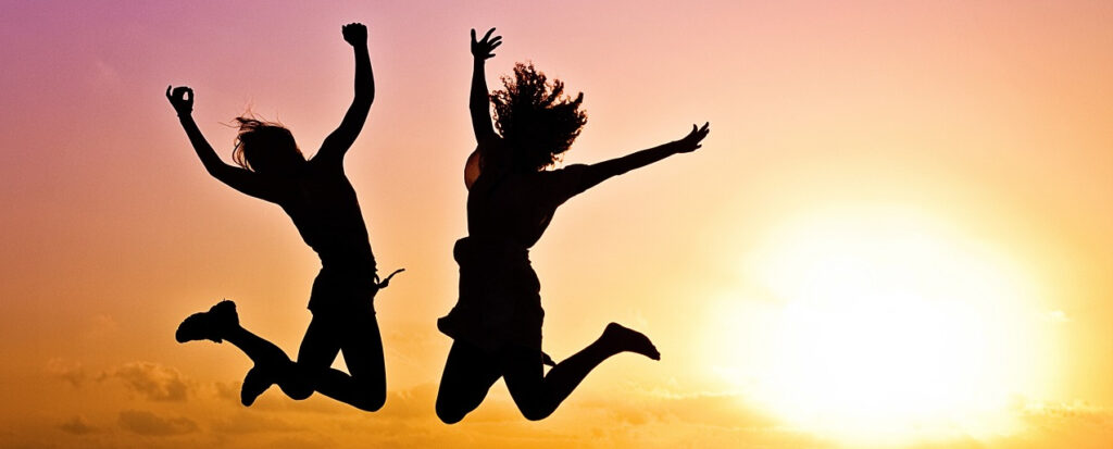 two people jumping in the air.