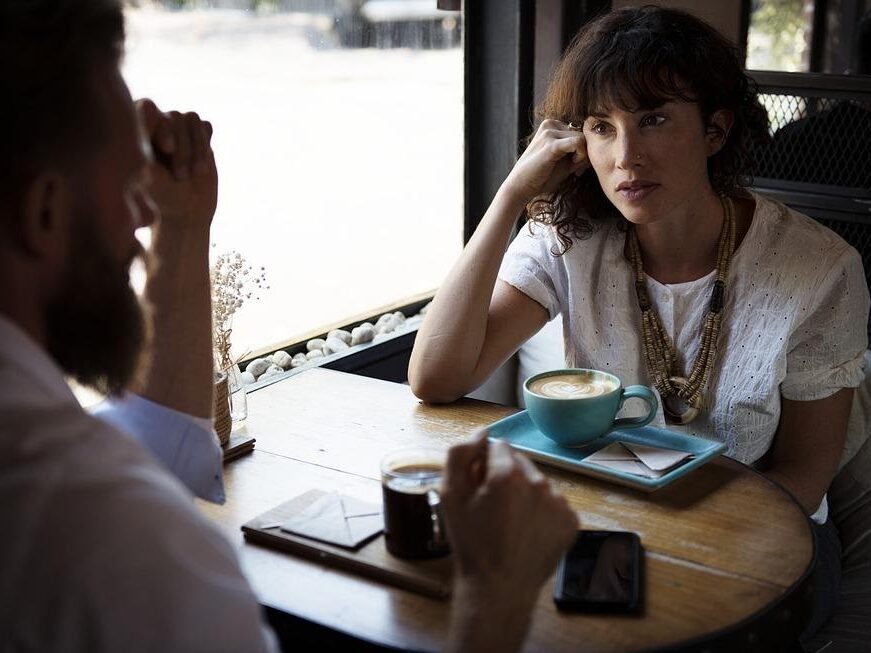 two people sitting in a coffee shop.