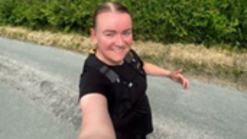 a person running whilst smiling for a selfie.